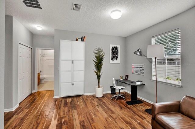 office featuring a textured ceiling and dark wood-type flooring