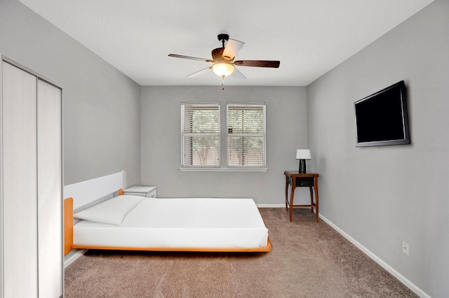 carpeted bedroom featuring ceiling fan