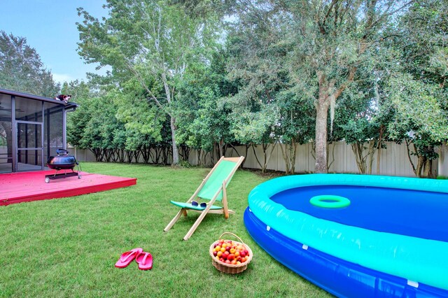 view of community featuring a deck and a yard