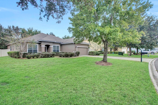 view of front of home featuring a garage and a front lawn