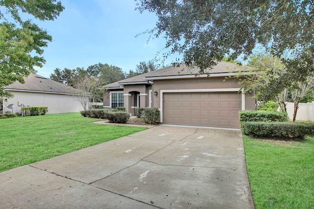 single story home featuring a garage and a front lawn