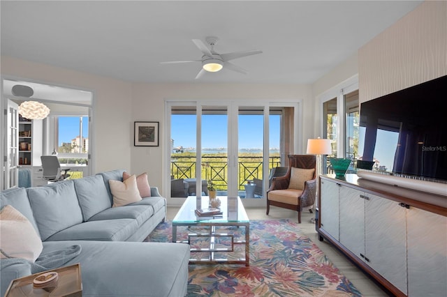 living room with ceiling fan and plenty of natural light