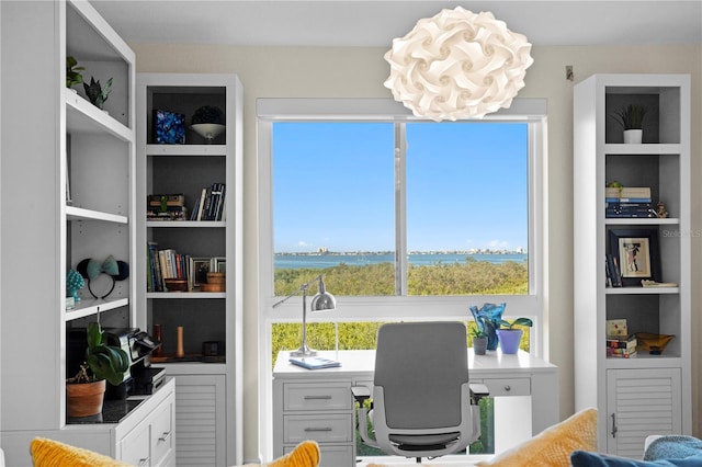 office area with a water view, built in features, and plenty of natural light