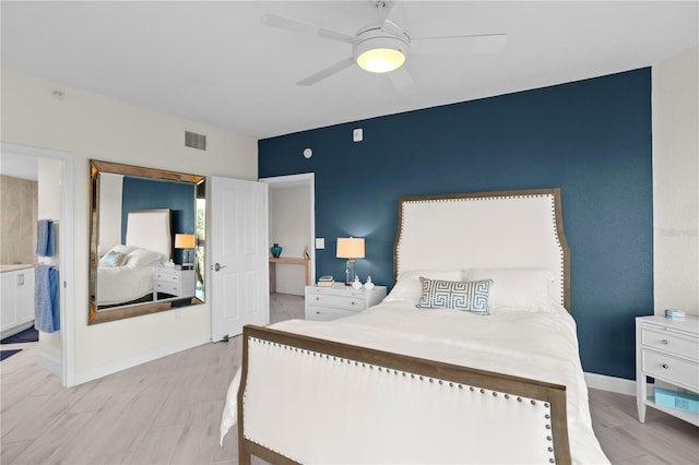 bedroom with ceiling fan, light hardwood / wood-style floors, and ensuite bath