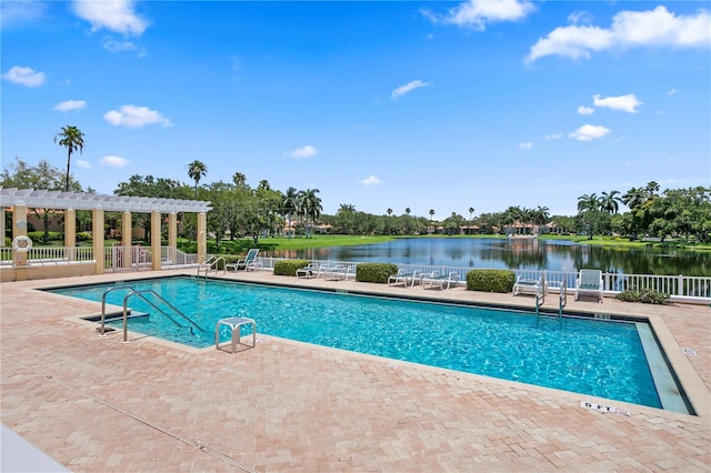 view of pool featuring a patio area, a water view, and a pergola