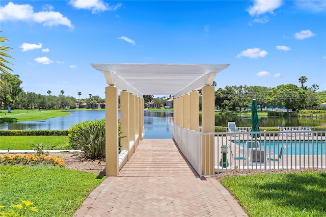 view of community featuring a patio area, a water view, and a pool