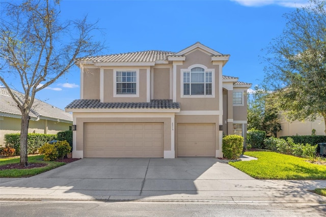 mediterranean / spanish-style house with a front yard and a garage