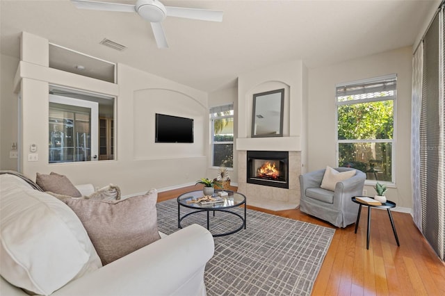 living room featuring ceiling fan and hardwood / wood-style floors