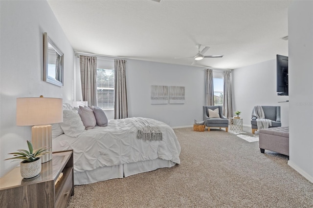 bedroom featuring carpet, ceiling fan, and multiple windows