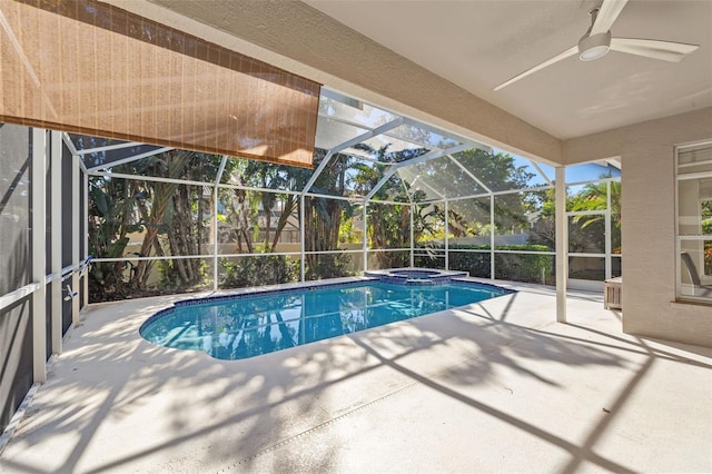 view of swimming pool featuring an in ground hot tub, a patio, ceiling fan, and a lanai