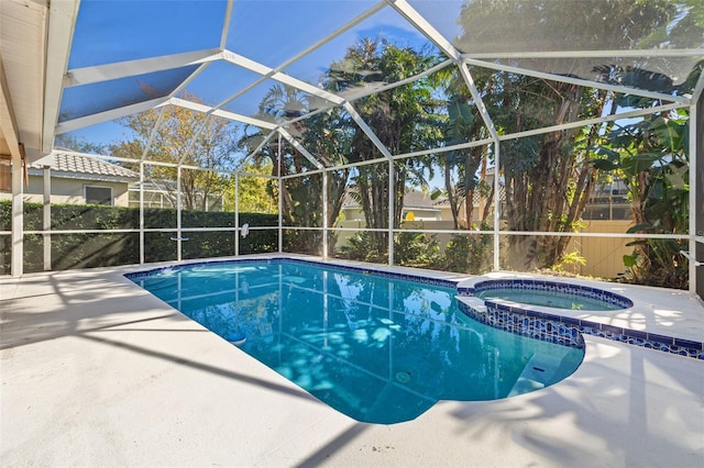 view of pool with glass enclosure, an in ground hot tub, and a patio