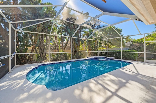 view of pool with an in ground hot tub, a patio, and a lanai