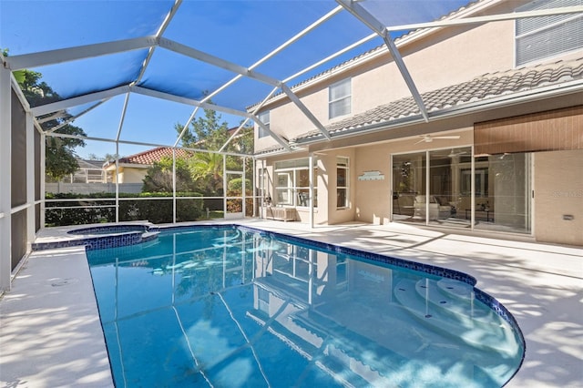 view of swimming pool featuring a lanai, an in ground hot tub, ceiling fan, and a patio