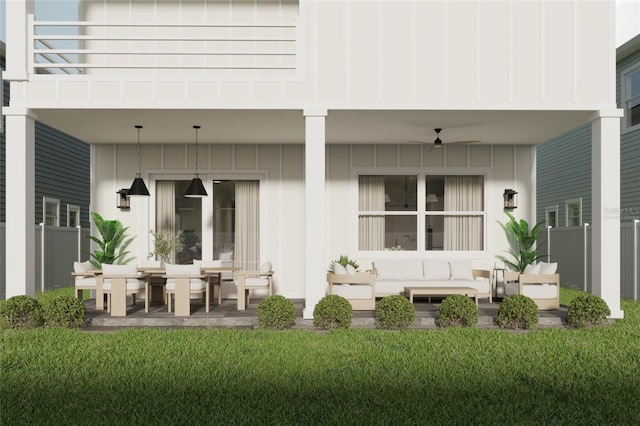 rear view of house with an outdoor living space, ceiling fan, a balcony, a yard, and a patio area