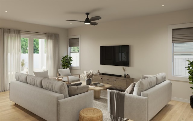 living room with ceiling fan and light hardwood / wood-style flooring