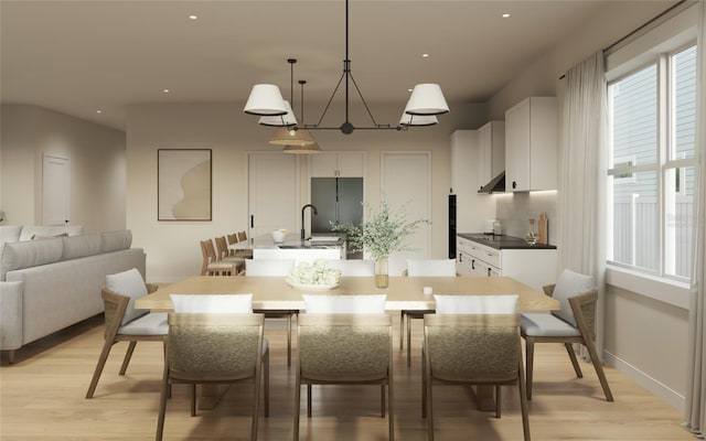 dining room featuring light wood-type flooring and sink