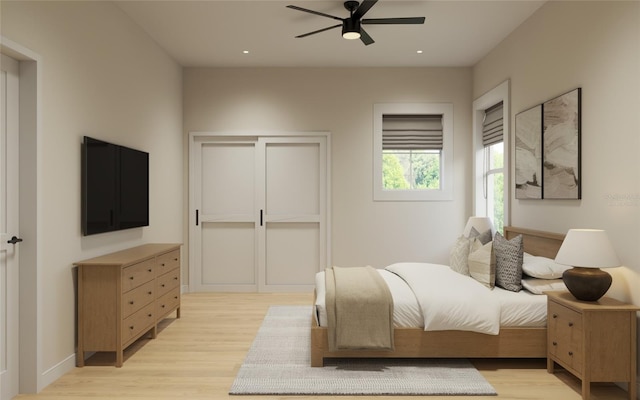 bedroom featuring light wood-type flooring and ceiling fan