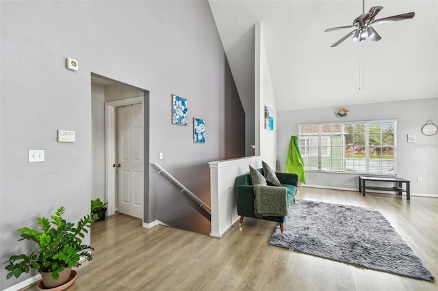 sitting room featuring ceiling fan, light hardwood / wood-style floors, and high vaulted ceiling