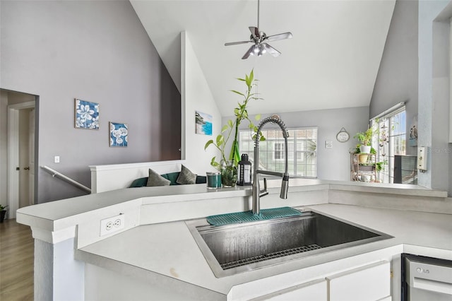 kitchen with hardwood / wood-style floors, white cabinetry, sink, ceiling fan, and kitchen peninsula