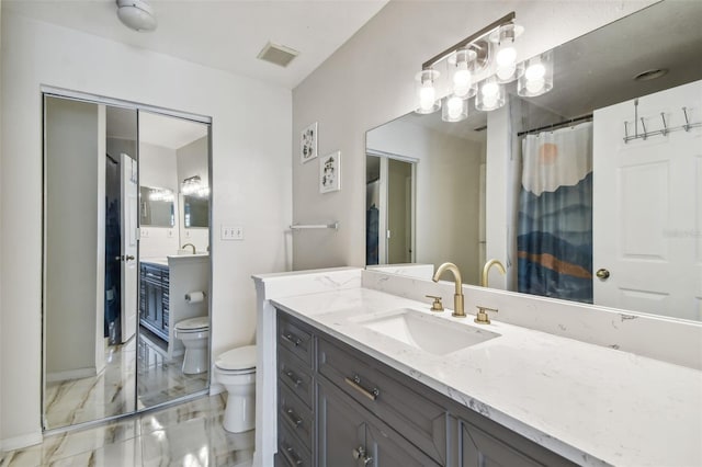 bathroom featuring vanity and toilet