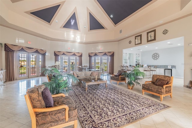 tiled living room with a towering ceiling and french doors