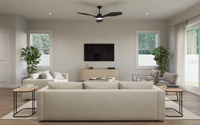 living room with ceiling fan and light hardwood / wood-style floors