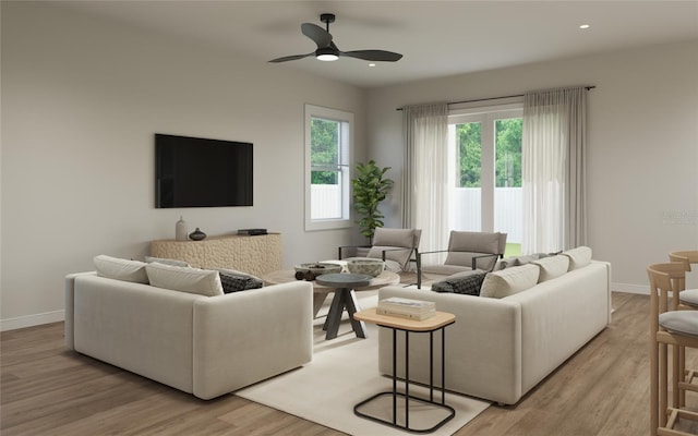 living room with ceiling fan and light hardwood / wood-style floors