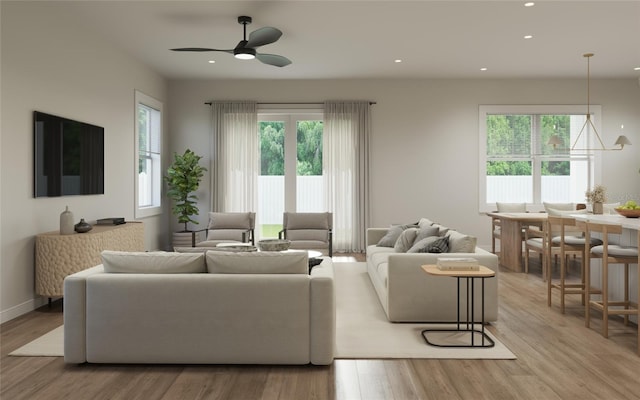 living room featuring ceiling fan and light wood-type flooring