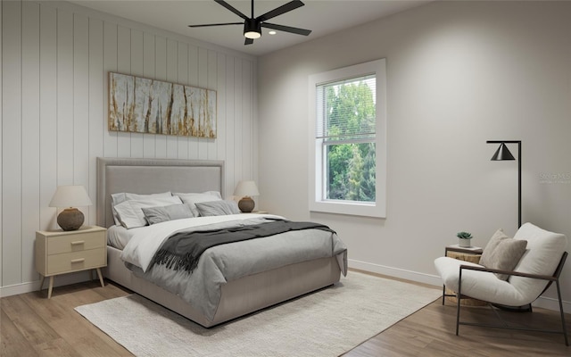 bedroom with light wood-type flooring, ceiling fan, and wood walls