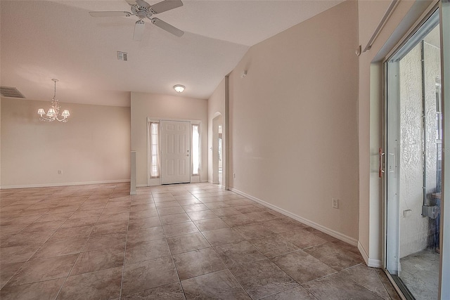 foyer with vaulted ceiling, plenty of natural light, light tile patterned flooring, and ceiling fan with notable chandelier