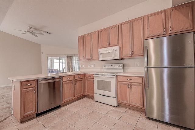 kitchen featuring vaulted ceiling, ceiling fan, light tile patterned floors, appliances with stainless steel finishes, and kitchen peninsula