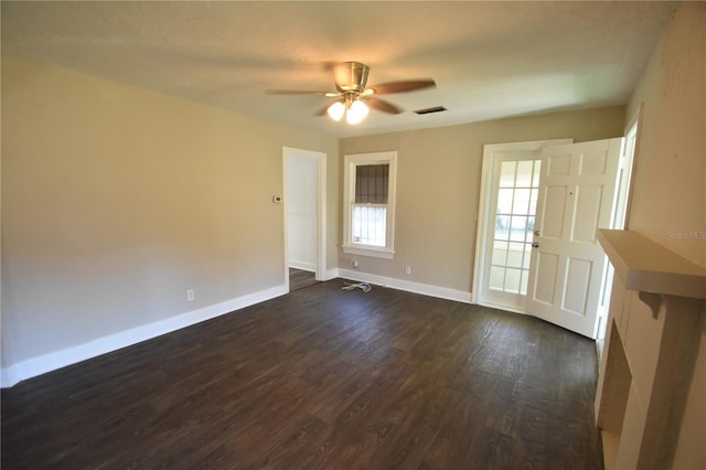 unfurnished room with ceiling fan and dark wood-type flooring