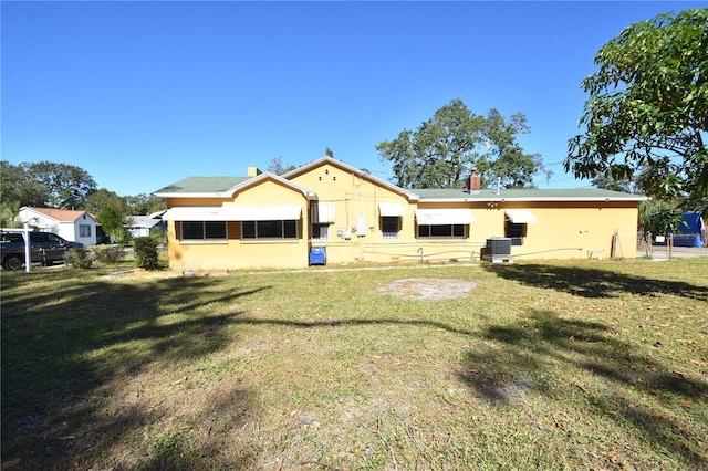 back of house with a lawn