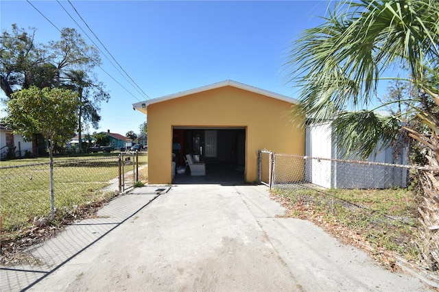 view of property exterior with a lawn, a garage, and an outbuilding