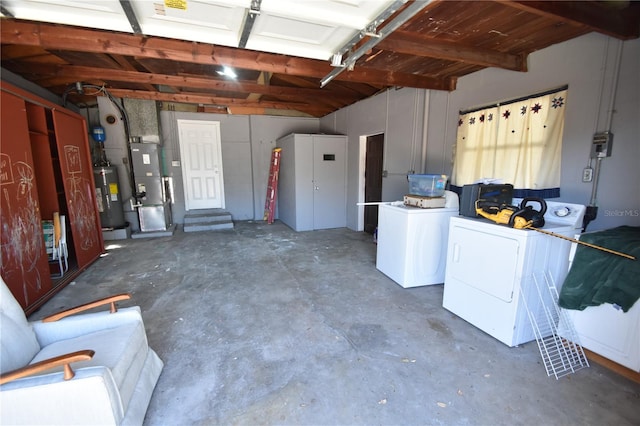 garage with washer and dryer, heating unit, and water heater