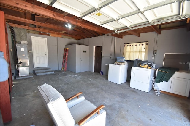 garage featuring separate washer and dryer and heating unit