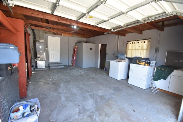 garage with washing machine and clothes dryer and heating unit