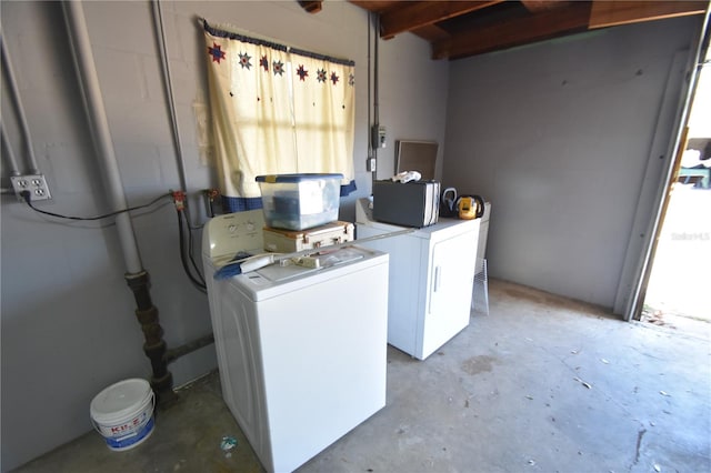 laundry area with a wealth of natural light and washing machine and clothes dryer