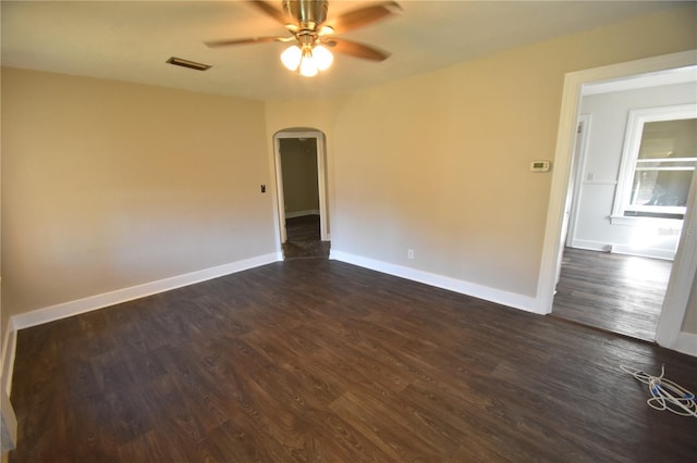 unfurnished room with ceiling fan and dark wood-type flooring