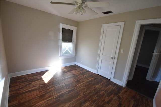 unfurnished bedroom with ceiling fan and dark hardwood / wood-style floors