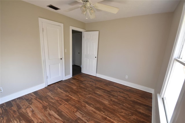 unfurnished bedroom with ceiling fan and dark hardwood / wood-style floors