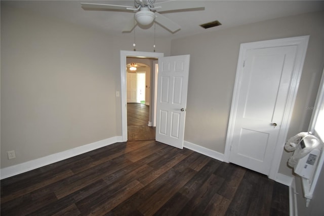 unfurnished bedroom with ceiling fan and dark hardwood / wood-style floors