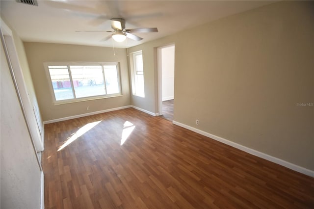 unfurnished room with dark hardwood / wood-style flooring and ceiling fan