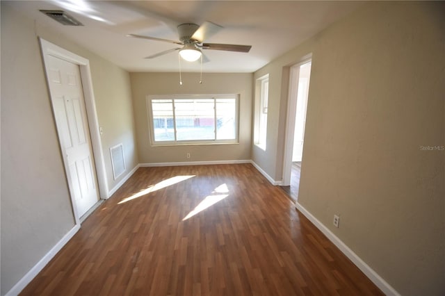 spare room with ceiling fan and dark hardwood / wood-style flooring