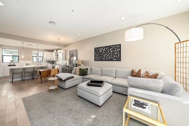 living room with wood-type flooring and a chandelier