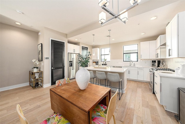 kitchen with white cabinets, a kitchen island, and appliances with stainless steel finishes