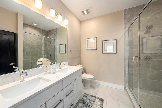 bathroom featuring tile patterned flooring, vanity, an enclosed shower, and toilet