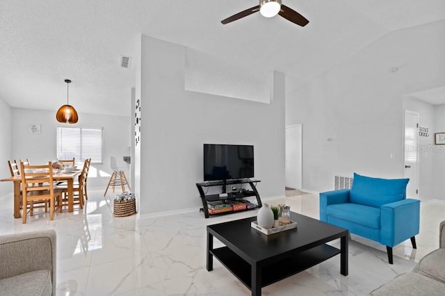 living room with a textured ceiling, ceiling fan, and lofted ceiling