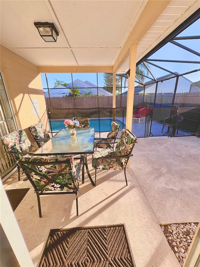 view of patio / terrace featuring glass enclosure