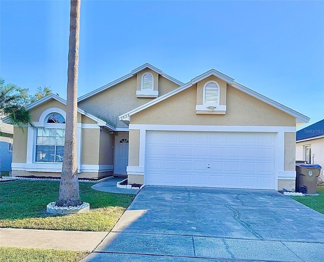 front facade with a garage and a front lawn